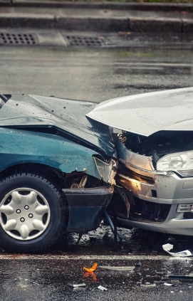Two sedans after a head-to-head collision on the road.